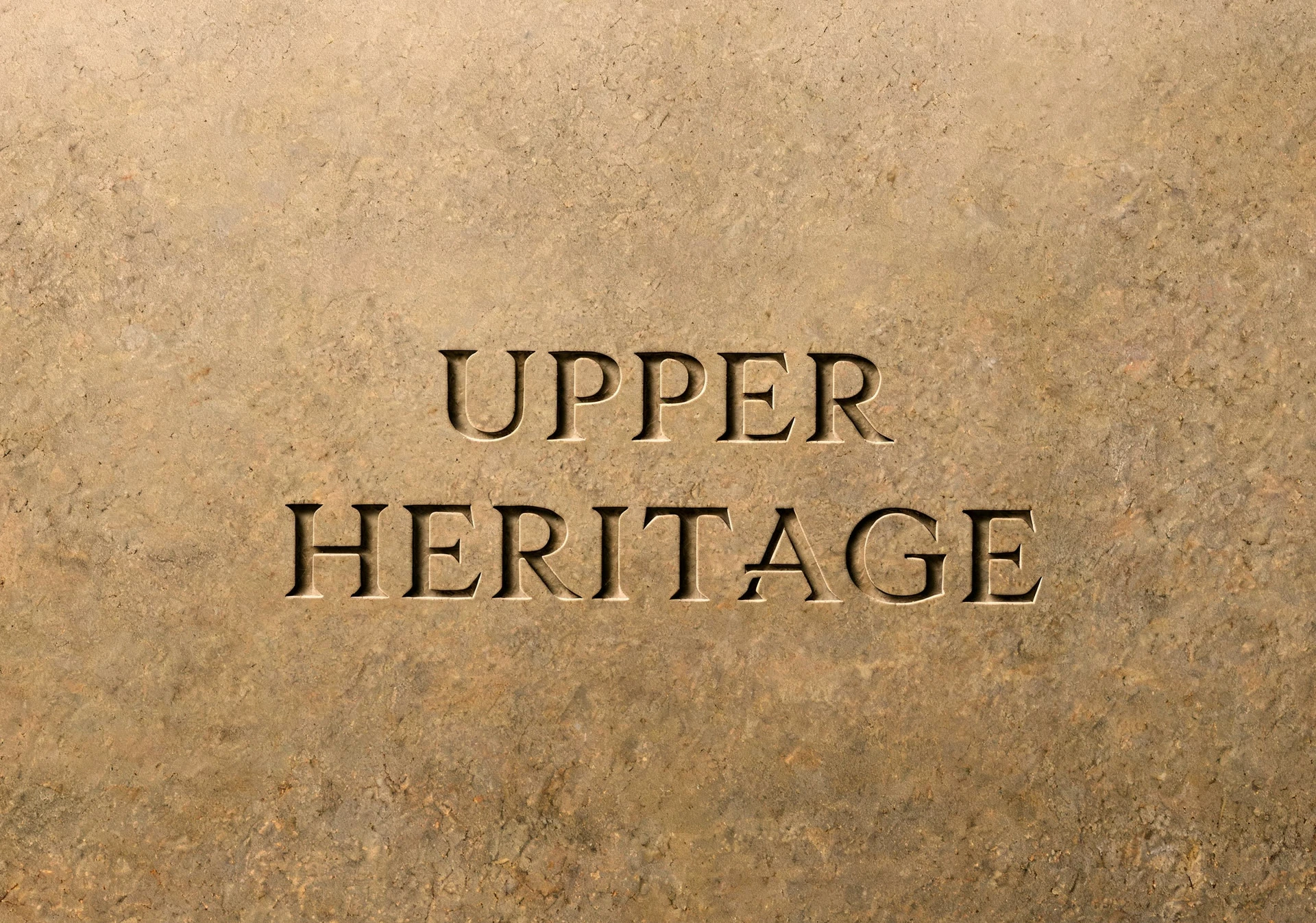 The Upper Heritage name engraved into a sandstone slab